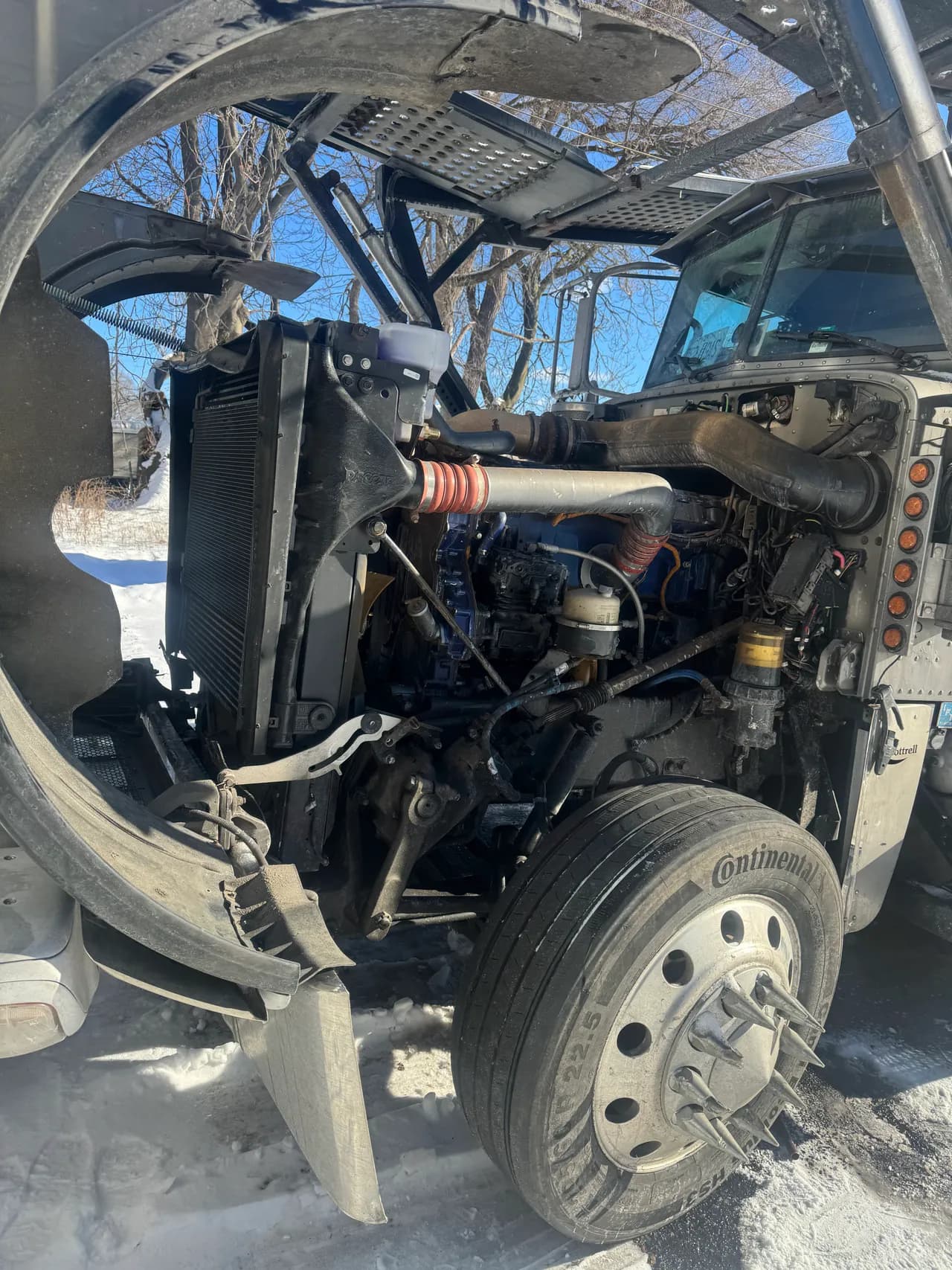 Semi truck with cab tilted forward exposing the engine bay for diagnostics