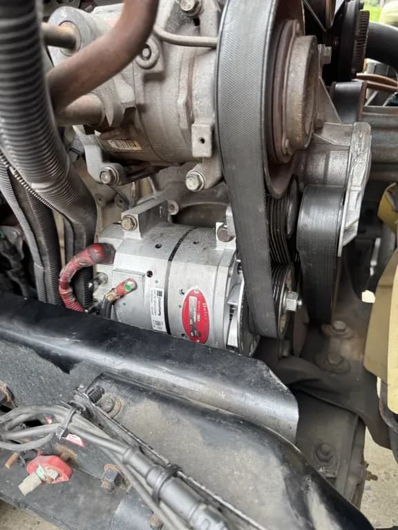 New serpentine belt installed on truck engine pulleys